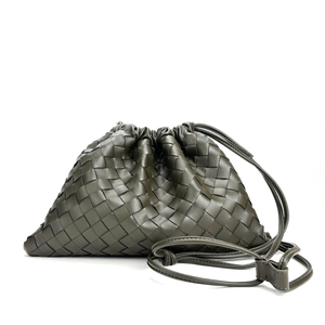 Elegant olive green woven leather crossbody bag with drawstring and shoulder strap