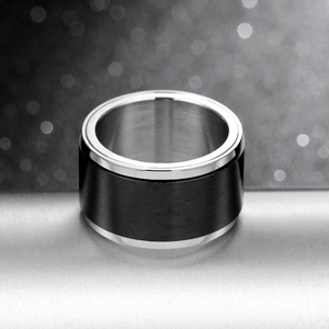 Detail of 8mm dual-tone black brushed metal and silver stainless steel spinning ring