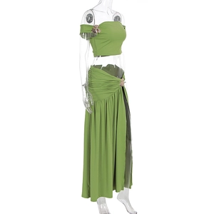 Detail of gold leaf buckle on grass green crop top and high slit skirt beach set