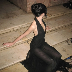 Artistic high-angle view of an elegant black halter dress with mesh hem and side knot