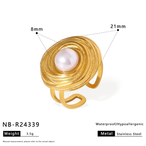 Detail of 8mm pearl ring with golden textured concentric relief on stainless steel band