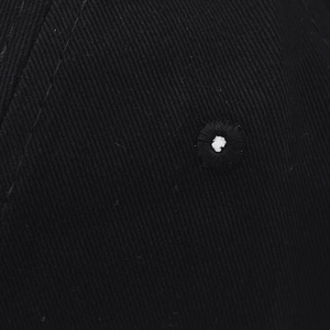 Close-up of black twill cotton fabric texture with white embroidered dot detail