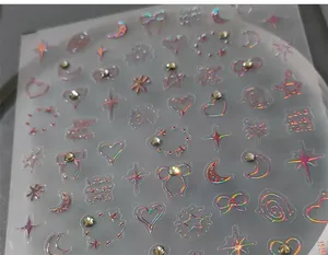 Detailed holographic nail stickers featuring 3D embossed stars, hearts and rhinestones