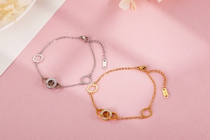 Close-up of gold and silver steel bracelets with K14 stamp and sparkling crystals