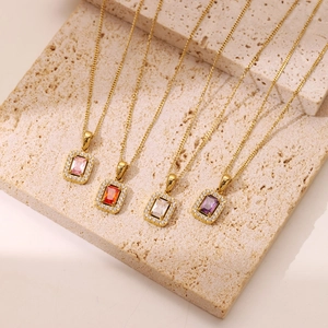 Elegant 18K gold plated necklaces with colorful square zircon pendants on stone background