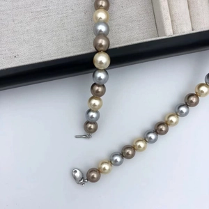 Macro shot of multi-color pearls necklace with gold, silver and champagne luster