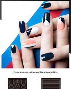 Detail of geometric DIY nail stickers featuring navy blue, orange, and white block patterns