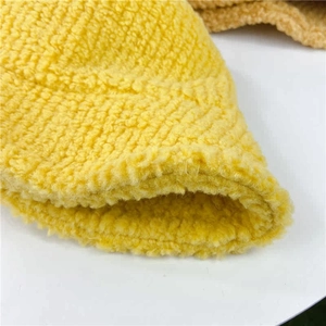 Detailed macro view of yellow twill lamb wool fabric showing soft thick texture