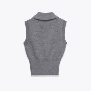 Detailed view of grey knitted vest with ribbed edges and high collar in macro shot