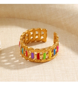 Detailed view of gold chain-style ring with vibrant multi-colored enamel dots on linen
