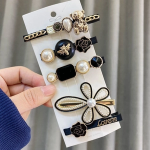 5-piece gold hair clip set featuring bear, bee, black rose, pearls and rhinestones