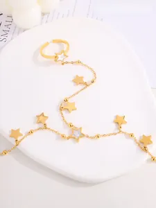 Detail of gold stainless steel star ring bracelet with white shell star charms