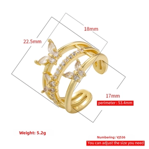 Detailed view of triple-layer gold ring featuring sparkling zircon butterfly accents