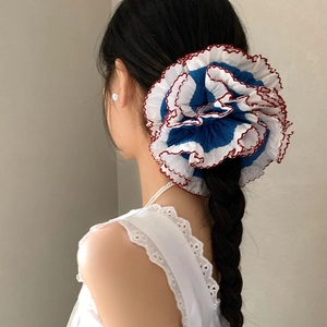 Blue and white lace scrunchie with red trim shown on a ponytail with lace blouse