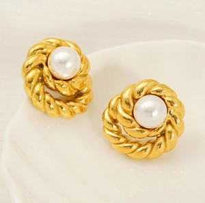 Macro shot of 18K gold-plated twisted rope earrings featuring a lustrous white pearl center