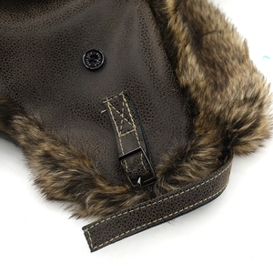 Detail of faux leather texture and faux fur lining with metal police snap on aviator hat