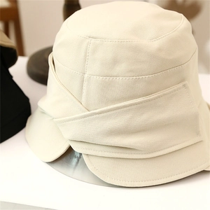 Detail of cross-layered fabric craftsmanship on wide brim off-white sun hat for women
