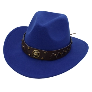 Macro detail of royal blue cowboy hat with brown leather band and horseshoe emblem