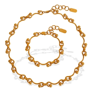 Gold wave link necklace and bracelet set with round beads and Lucky charm tag