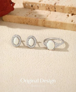 Detailed view of elegant silver jewelry set with oval white opal stones and crystals