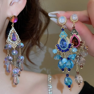Detailed close-up of luxury crystal tassel earrings featuring sparkling bohemian rhinestones