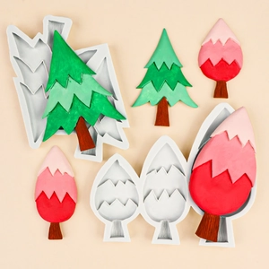 Silicone tree molds for cake decorating and chocolate showing finished green and red trees