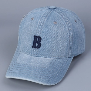 Detail of light blue denim baseball cap with a dark blue embroidered letter B logo