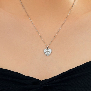 Detailed close-up of a heart pendant necklace featuring a zircon-encrusted paw print