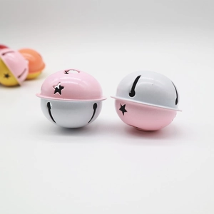 Close-up of 4cm pink and white bicolored metal bells with star-shaped cutout patterns