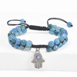 Detail of beaded Hamsa hand bracelet with Evil Eye charm and faceted crystals