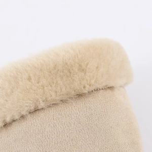 Detail of beige fleece trim and textured knit fabric on a reversible women's jacket