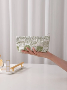 Minimalist cotton linen makeup bag with green floral embroidery and H&R BAG logo label