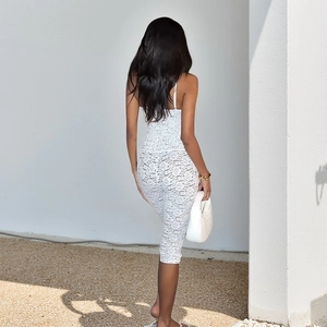 Detailed back view of white lace romper showing intricate floral hollow-out patterns