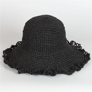 Detail of black crochet straw sun hat featuring elegant wavy brim texture and thick weave