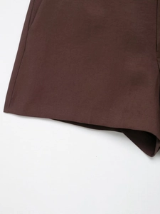 Detail shot of chocolate brown tailored shorts with high-density fabric and neat stitching