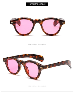 Detail view of tortoiseshell frame sunglasses with pink lenses and durable metal hinges