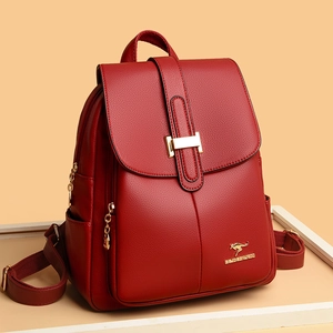 Deep red pebbled leather backpack for women with golden hardware on neutral background