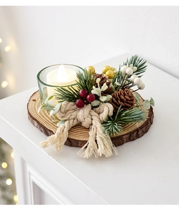 Macro detail of Christmas candle holder with pine cones berries and rustic wood base