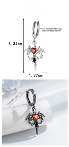 Detail of gothic bat wing earrings with red heart zircon and black spike pendant