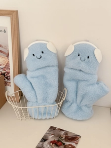 Detailed close-up of blue plush flip-top gloves featuring a cute cartoon smiley face
