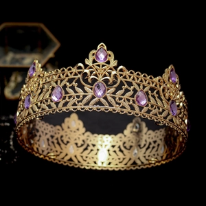 Detailed macro view of vintage gold crown with intricate filigree and purple gemstones