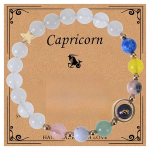 Detail of Capricorn zodiac bracelet with blue sand stone beads and golden star charm