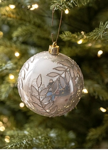 Dettaglio di una pallina di Natale bianco perlato con texture a foglia glitterata su albero