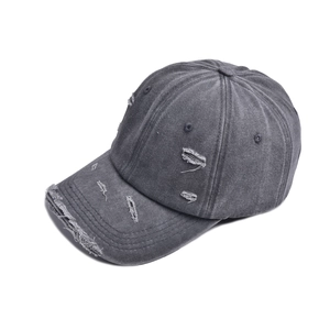 Close-up of distressed brim details on a dark grey washed cotton baseball cap