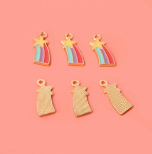 Detail of six gold alloy rainbow star charms with colorful enamel for DIY jewelry making