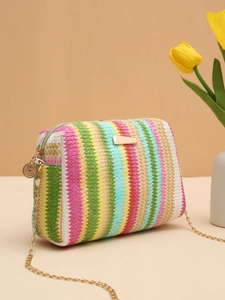 Detail of colorful rainbow straw camera bag with gold chain strap and metal zipper