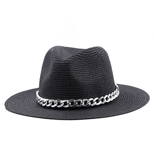 Close-up of black straw fedora hat with a decorative silver metal chain detail