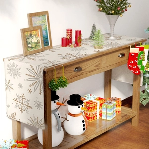 Detailed cream Christmas table runner with snowflake patterns and festive decor