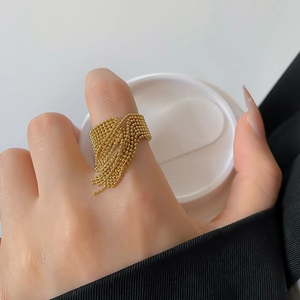 Detailed view of a gold beaded tassel ring showing high-quality metallic luster and texture