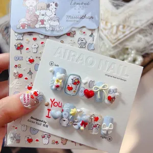 Detailed view of embossed cartoon dog and bear nail stickers with light blue heart accents